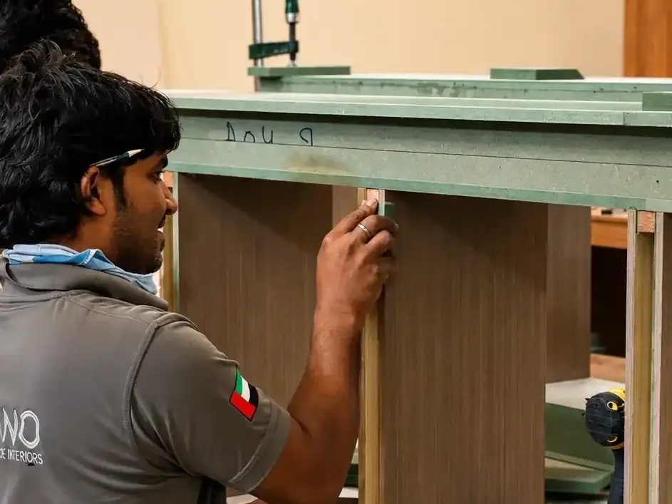 Divano craftsman fitting a veneered panel into a bespoke unit
