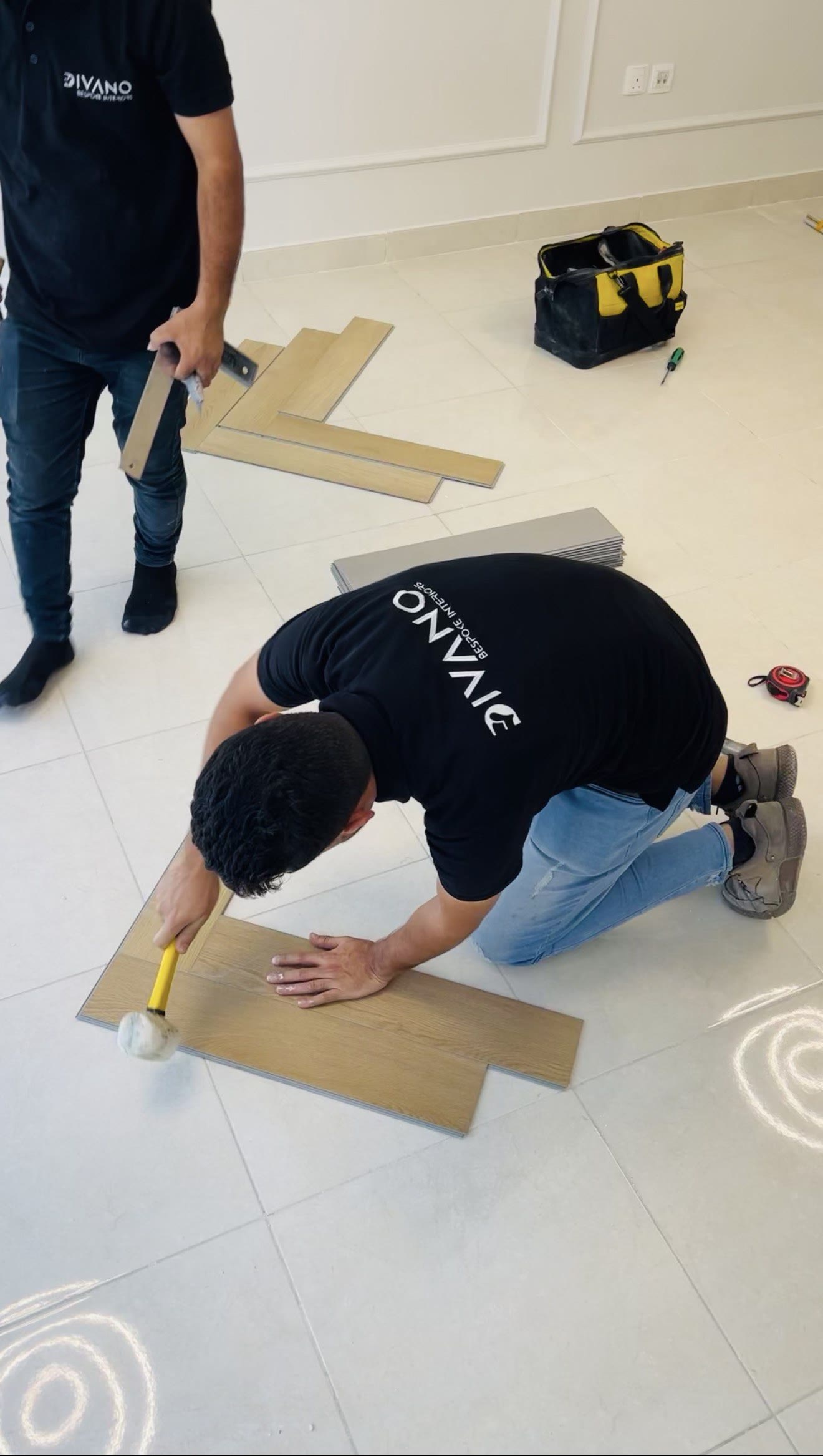 Divano fitters laying engineered plank flooring